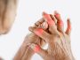 Asian woman hand suffering from joint pain with gout in finger